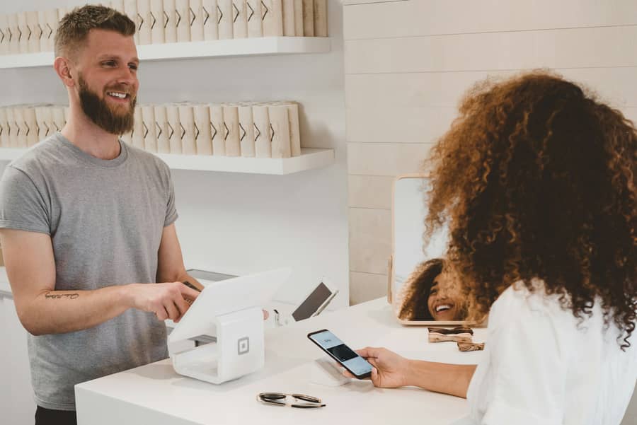 Customer paying on a phone at a shop counter
